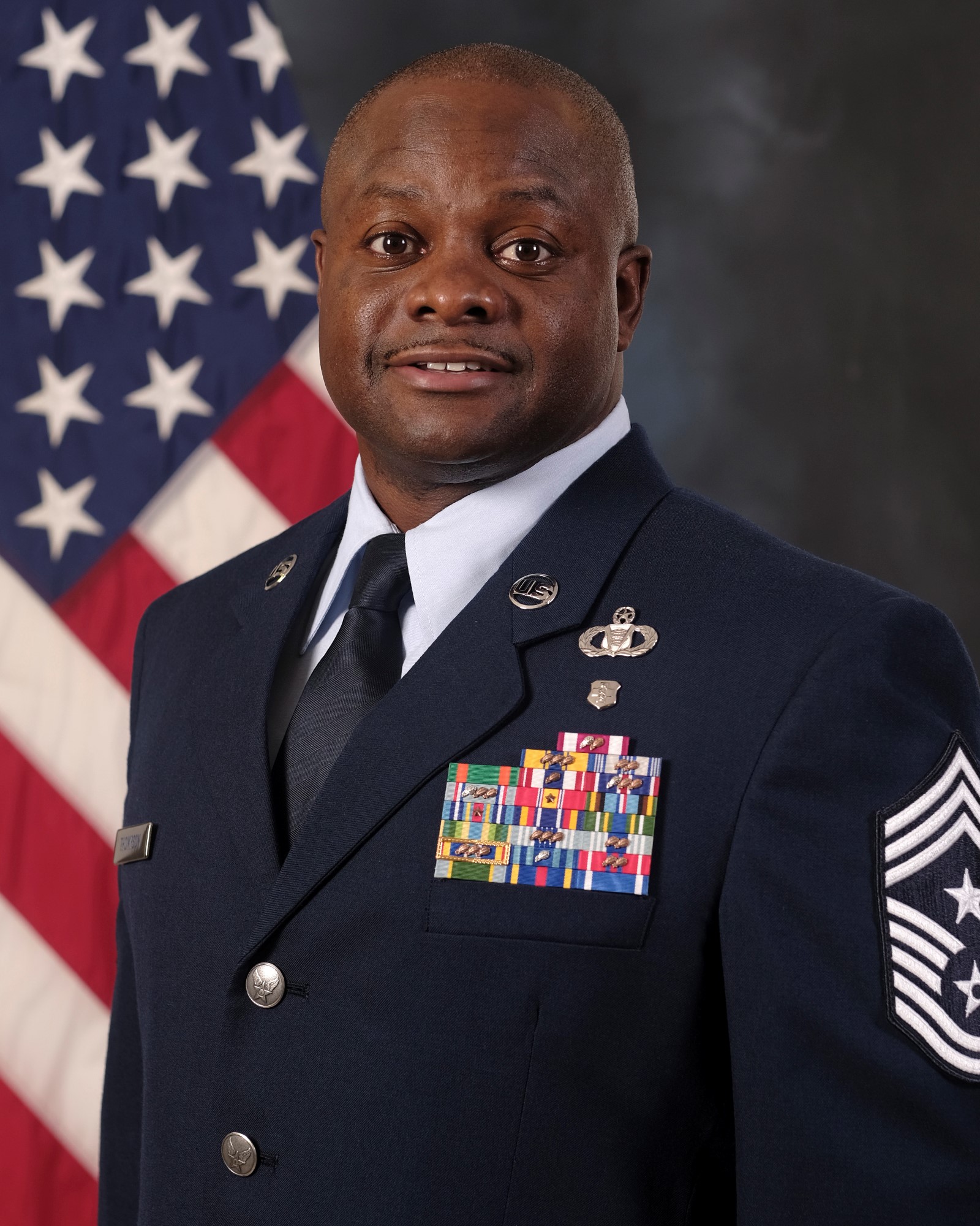 Photo of CMSgt Cornelious "CT" Thompson with U.S. Flag in background